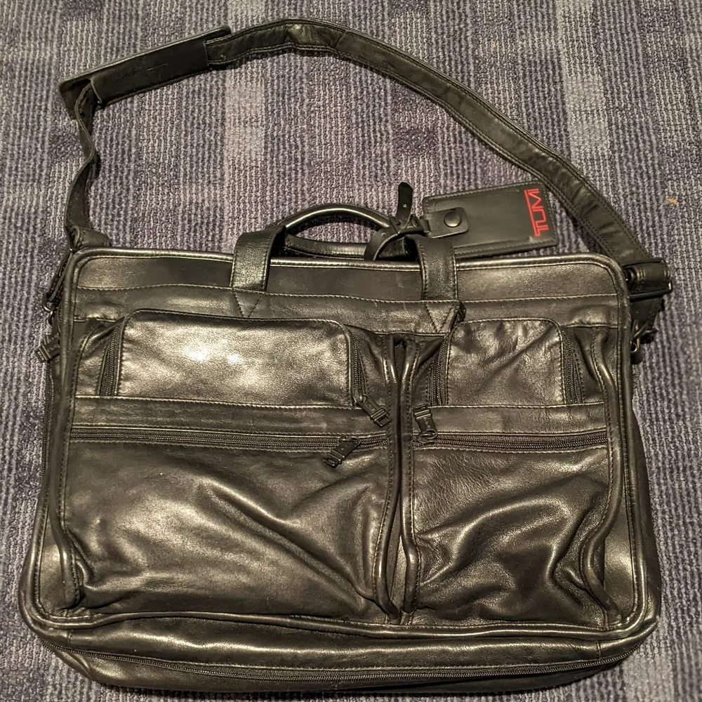 Black Tumi expandable briefcase. Fits 15